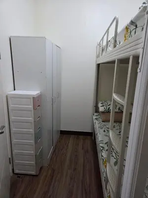 a room with two bunk beds and a dresser at Minimalist stay in Satori Residences Pasig City in Manila