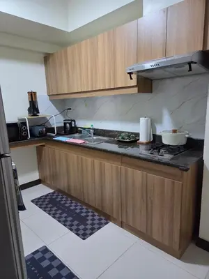 a kitchen with a sink and a counter top at Minimalist stay in Satori Residences Pasig City in Manila
