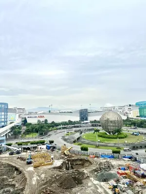 a construction site with a large building in the background at Grace era Staycation in Manila