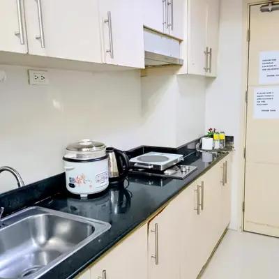 a kitchen with a sink and a counter top at Grace era Staycation in Manila