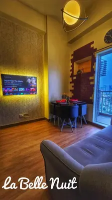 a living room with a couch and a table at Prisma La Belle Nuit in Manila