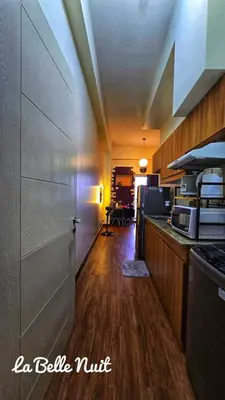 a room with a kitchen with a counter top at Prisma La Belle Nuit in Manila