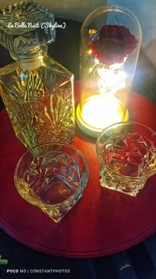 a table with two glass vases and a candle at Prisma La Belle Nuit in Manila