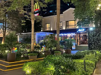 a building with a bunch of plants in front of it at 55-SQM 1-BR golf club view condo in Central BGC in Manila