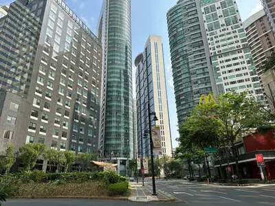 a street in a city with tall buildings at 55-SQM 1-BR golf club view condo in Central BGC in Manila