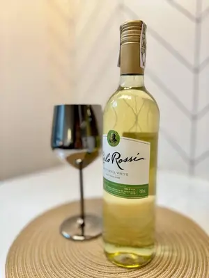 a bottle of wine sitting next to a wine glass at Stunning 42nd Floor Apt with Netflix in Manila