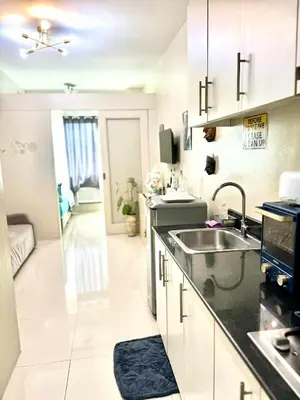 a kitchen with a sink and a counter top at Vince era staycation in Manila