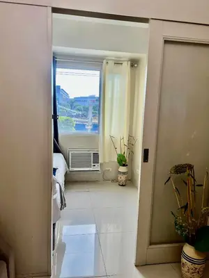 an open door to a room with a window at Rhon's Staycation in Manila