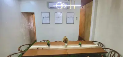 a table with two birds sitting on top of it at Cozy Villa with Dipping Pool in Bacoor