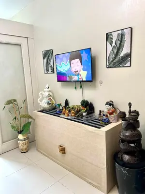 a room with a flat screen tv on a wall at V&G era staycation in Manila