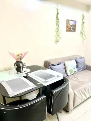 a living room with a table and a couch at V&G era staycation in Manila