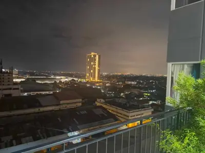 a view of a city at night from a building at S-Line - Your place, your comfort! in Manila