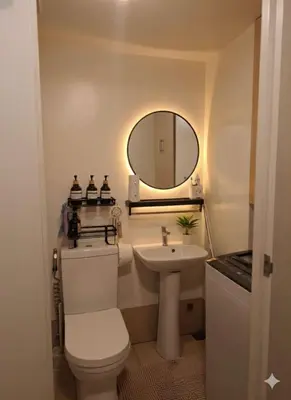 a bathroom with a white toilet and a sink at S-Line - Your place, your comfort! in Manila