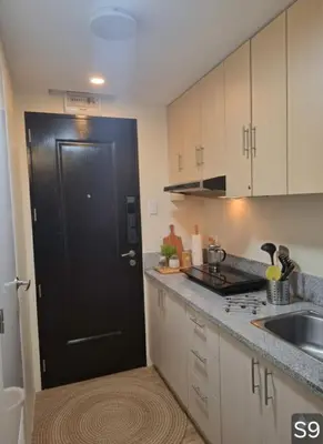 a kitchen with a black door and a sink at S-Line - Your place, your comfort! in Manila
