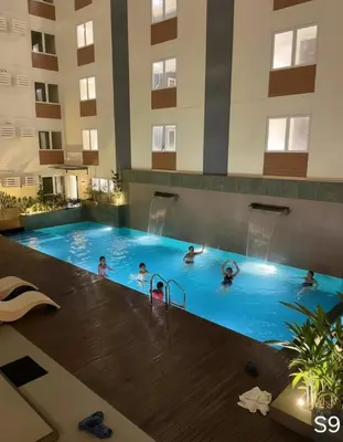 a group of people in a swimming pool in a hotel at S-Line - Your place, your comfort! in Manila
