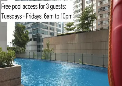 a swimming pool in front of a building at Explore Mitsukoshi BGC with pool and wifi in Manila