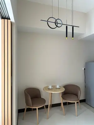 a dining room with a table and two chairs at Cozy 1-Bedroom in Uptown Parksuites BGC in Manila