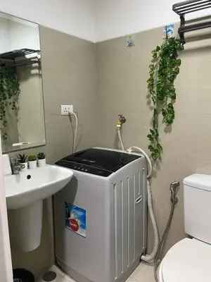 a bathroom with a sink and a toilet at Maria Solace in Manila