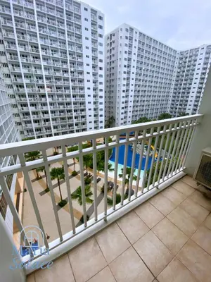 a balcony with a view of tall buildings at Maria Solace in Manila