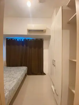 a small room with a bed and a window at Light Residence Condo with Balcony and Pool View in Manila