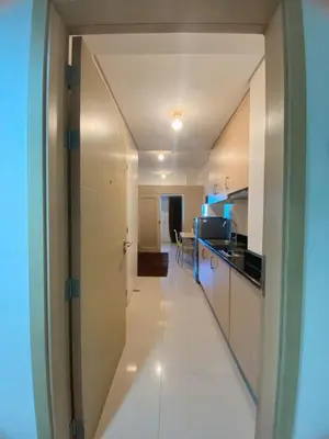 a hallway leading to a kitchen in a apartment at Light Residence Condo with Balcony and Pool View in Manila