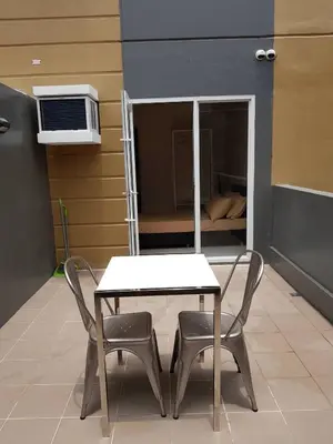 a table and two chairs in a room with a bed at 1 BR Taytay HIVE Condo WIFI Netflix Pool Patio in Taytay