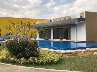 a building with a swimming pool in front of it at 1 BR Taytay HIVE Condo WIFI Netflix Pool Patio in Taytay