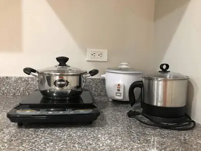 a slow cooker and a tea pot on a blender at 1 BR Taytay HIVE Condo WIFI Netflix Pool Patio in Taytay