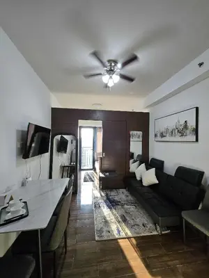 a living room with a couch and a table at The Air Residences Makati in Manila