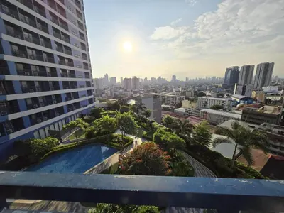 a view of the city from the balcony of a building at The Air Residences Makati in Manila