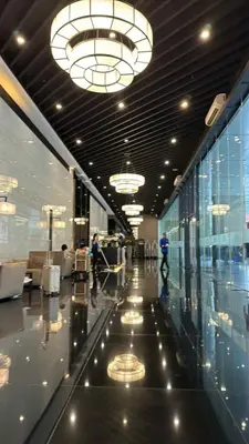 a large lobby with people walking in a building at The Air Residences Makati in Manila