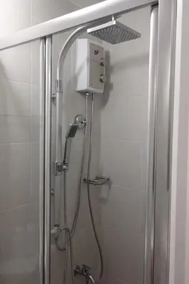 a shower in a bathroom with a glass door at 1 BR Makati JAZZ Condo WIFI Netflix Pool Balcony in Manila