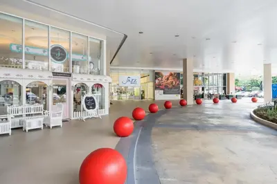 a shopping mall with red balls in the middle at 1 BR Makati JAZZ Condo WIFI Netflix Pool Balcony in Manila