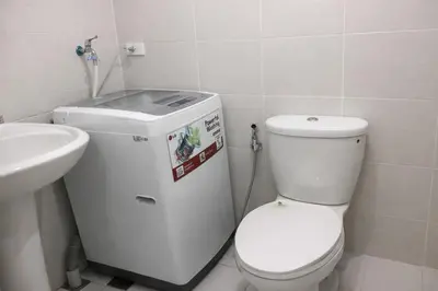 a bathroom with a toilet and a sink at 1 BR Makati JAZZ Condo WIFI Netflix Pool Balcony in Manila