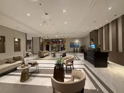 a lobby with couches and chairs in a building at 81 Newport Boulevard across NAIA T3 Airport in Manila