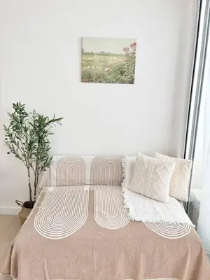 a bedroom with a bed with a painting on the wall at Playa Delea Minimalist Azure 1BR Pool Beach Staycation in Manila