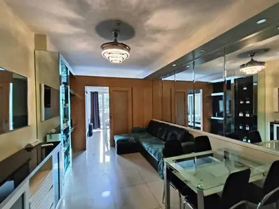 a living room with a couch and a glass table at Premiere Haven MOA Staycation in Manila