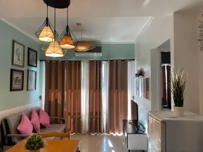 a living room with a couch and a table at Premiere Haven MOA Staycation in Manila