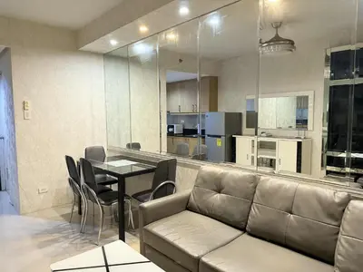 a living room with a couch and a table at Premiere Haven MOA Staycation in Manila