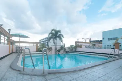 a swimming pool on the side of a building at Urban Travellers Hotel by RedDoorz in Manila