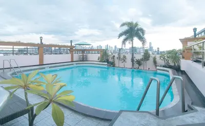 a large swimming pool on top of a building at Urban Travellers Hotel by RedDoorz in Manila