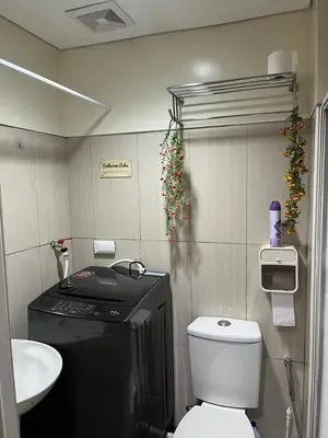 a small bathroom with a toilet and a sink at MOA Staycation Condotel PASAY in Manila