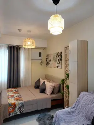 a bedroom with a bed and a couch in it at 25mins from NAIA1 in Manila