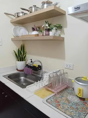 a kitchen sink with a dish drying rack next to it at 25mins from NAIA1 in Manila