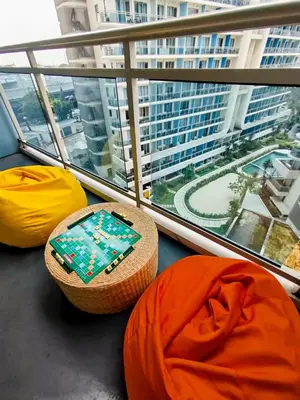 a balcony with a view of a large building at Azure Staycation with Pool View, Wifi and Netflix in Manila