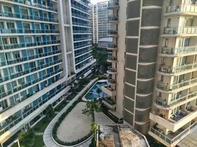 an aerial view of a courtyard between two tall buildings at Azure Staycation with Pool View, Wifi and Netflix in Manila