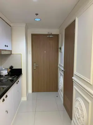 a kitchen with a door in the middle of a room at Chateau Lumiere Staycation at MOA in Manila
