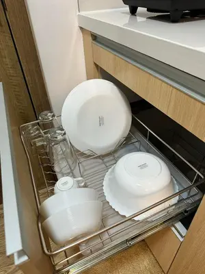two plates and bowls are sitting in a drawer at Studio City Staycation in Alabang in Manila
