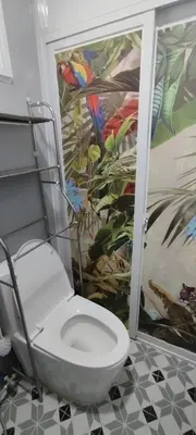 a bathroom with a toilet with a painting on the wall at 6 Guest - Unit 6 Studio type - Container house in Pasong Mannga