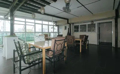 a dining room with a wooden table and chairs at RedDoorz at Regina Hometel J Victor in Manila